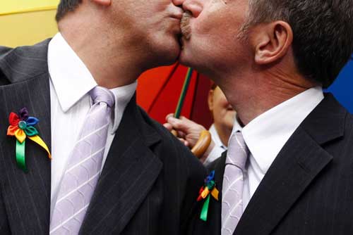Partners kiss at a gay marriage ceremony - Photo credit: abcnetau