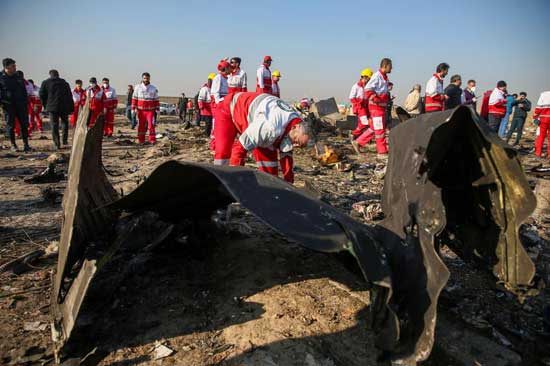 Red Crescent workers check the debris from the Ukraine International Airlines plane, that crashed after take-off from Iran's Imam Khomeini airport, on the outskirts of Tehran, Iran January 8, 2020. File photo