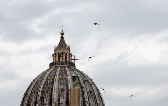The sky above St. Peter's Dome at the Vatican is overcast, on Tuesday, July 27, 2021. A trial is slated to begin on Tuesday within the Vatican City’s imposing walls of 10 defendants, including a once-powerful cardinal, in a case based on a sprawling probe into the allegedly criminal management of the Holy See’s portfolio of assets, including donations by countless Catholics from the pews. (AP Photo/Riccardo De Luca)