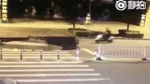 Motorcyclist plunges into sinkhole in China while fiddling with his phone